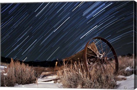 Framed Abandoned farm equipment against a backdrop of star trails Print