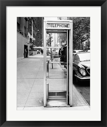 Framed Car parked at the side of a road near a telephone booth Print