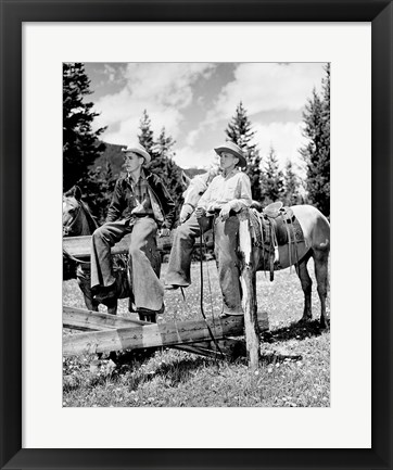 Framed Teenage cowboys sitting on rail fence Print