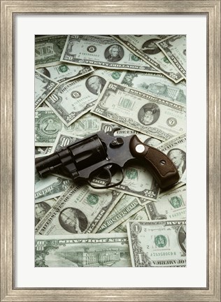 Framed Close-up of a handgun with paper currency Print