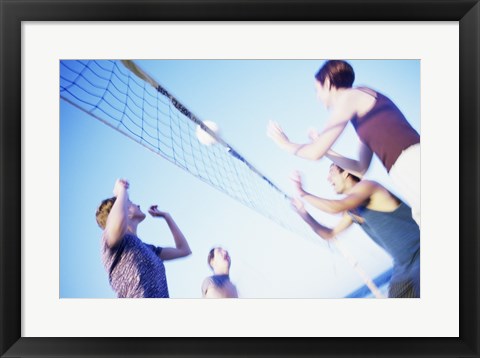 Framed Low angle view of two young couples playing beach volleyball Print