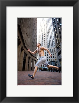 Framed Side profile of a young man running in a city Print