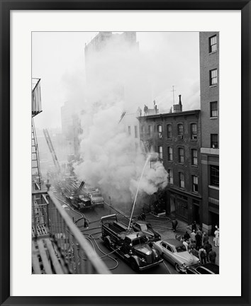 Framed New York City, Fire on East 47th Street, with fire engines shooting water on burning building Print