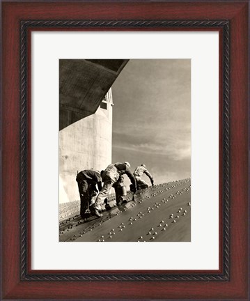 Framed Three construction workers putting a coat of paint on a slanted wall of riveted-steel plates on the Hoover Dam spillway Print