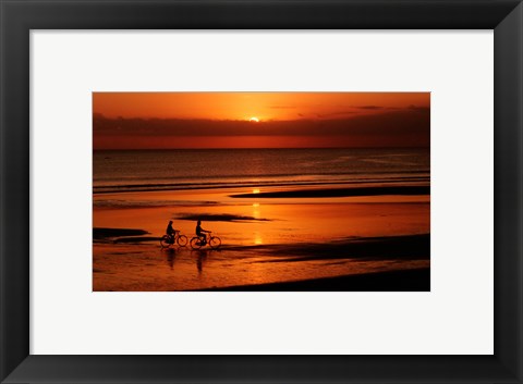 Framed Silhouette of a young couple cycling on the beach Print