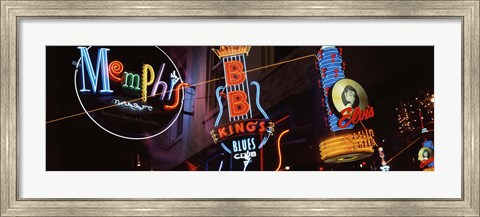 Framed Low angle view of neon signs lit up at night, Beale Street, Memphis, Tennessee, USA Print