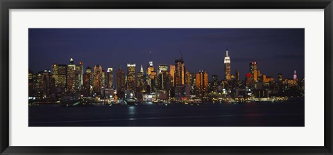 Framed Skyscrapers lit up at night in a city, Manhattan, New York City, New York State, USA Print