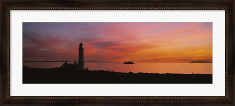 Framed Silhouette of a lighthouse at sunset, Scotland Print