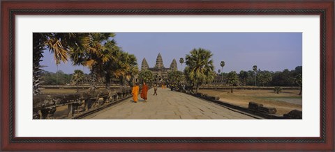 Framed Two monks walking in front of an old temple, Angkor Wat, Siem Reap, Cambodia Print