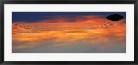 Framed Reflection of clouds with circular ripples spreading outward across glassy lake waters at sunset Print