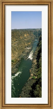 Framed Kayakers paddle down the Zambezi gorge away from the Victoria Falls, Zambia Print