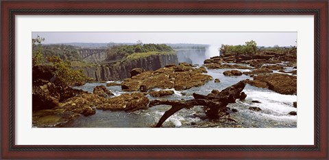 Framed Log on the rocks at the top of the Victoria Falls with Victoria Falls Bridge in the background, Zimbabwe Print