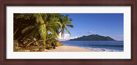 Framed Palm trees grow out over a small beach with Silhouette Island in the background, Seychelles Print