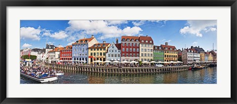 Framed Tourists in a tourboat with buildings along a canal, Nyhavn, Copenhagen, Denmark Print