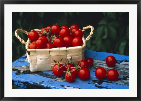 Framed Still life of cherry tomatoes in a rectangular woven basket sitting on distressed blue painted table top Print