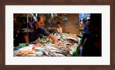 Framed Fishmonger at a fish stall, La Boqueria Market, Ciutat Vella, Barcelona, Catalonia, Spain Print