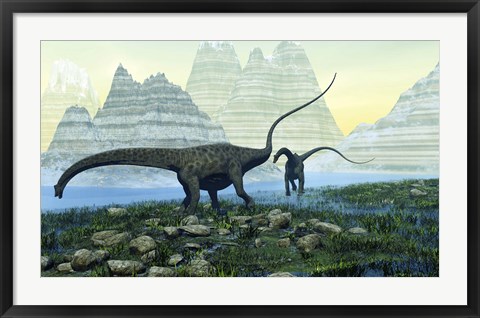 Framed Diplodocus dinosaurs munch on vegetation near a mountain lake Print