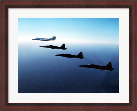 Framed Three F-5E Tiger IIs fly in formation with a Learjet 25 Print