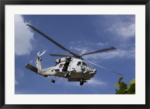 Framed Crew Chief looks out the side door of a helicopter in flight Print