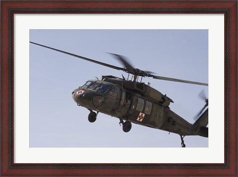 Framed UH-60 Blackhawk Medivac helicopter flies over Camp Warhorse Print