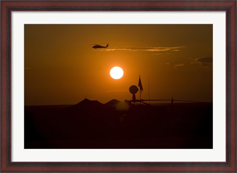 Framed UH-60 Blackhawk Flies Over Camp Speicher Airfield at Sunset Print