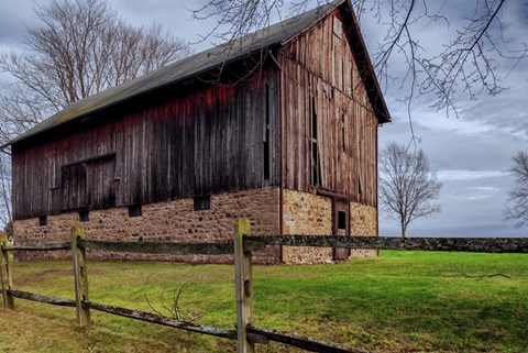 Framed Weathered Barn Under Threatening Sky Print
