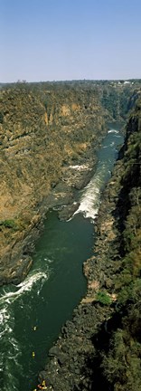 Framed Kayakers paddle down the Zambezi gorge away from the Victoria Falls, Zambia Print