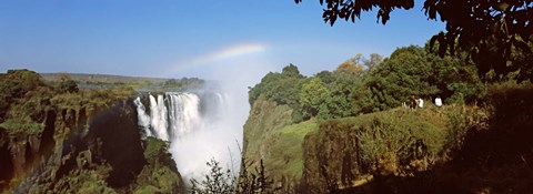 Framed Tourists at a viewing point looking at the rainbow formed over Victoria Falls, Zimbabwe Print