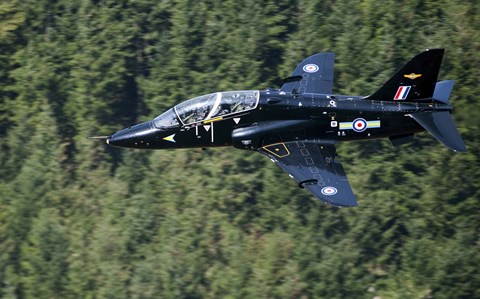 Framed Hawk T1 trainer aircraft of the Royal Air Force flying over a forest in North Wales Print