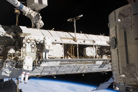 Framed Astronauts continue Maintenance Activities outside the International Space Station Print