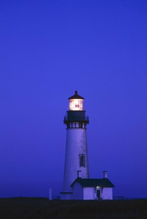 Framed Lit Up Lighthouse at Night Print