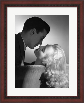 Framed Movie Star Studio Style Romantic Couple Embracing On Sofa About To Kiss Print