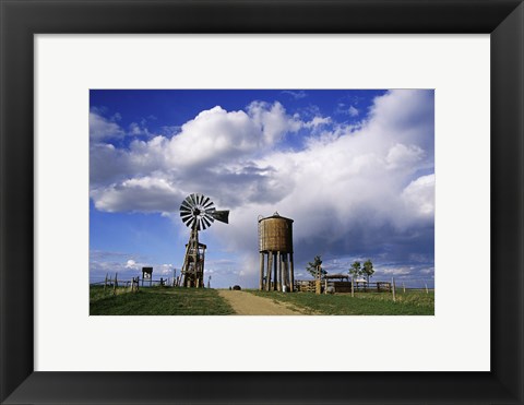 Framed Low angle view of a water tower and an industrial windmill, 1880 Town, South Dakota, USA Print