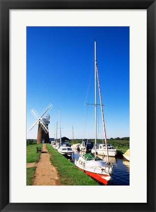Framed Boats moored near a traditional windmill, Horsey Windpump, Horsey, Norfolk Broads, Norfolk, England Print