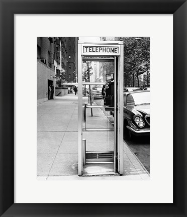Framed Car parked at the side of a road near a telephone booth Print