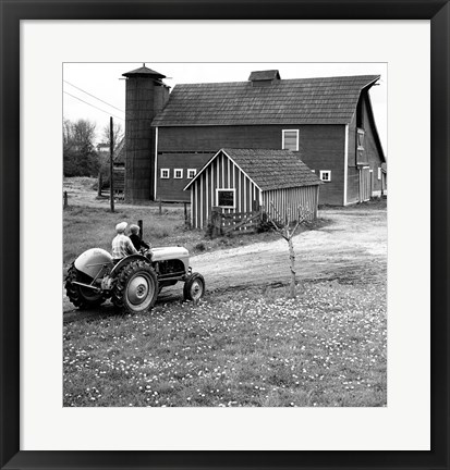 Framed Man with a Boy Riding a Tractor in a Field Print