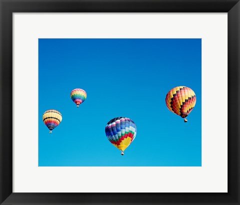 Framed 4 Rainbow Hot Air Balloons in the Bright Blue Sky Print