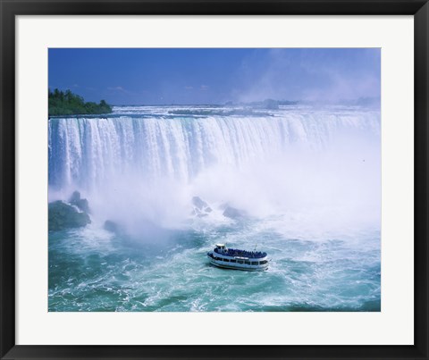 Framed High angle view of a tourboat in front of a waterfall, Niagara Falls, Ontario, Canada Print