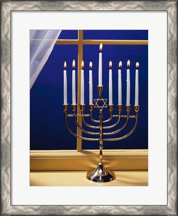 Framed Close-up of burning candles on a menorah at a window Print