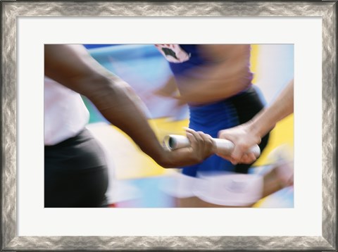Framed Mid section view of runners exchanging baton at a relay race Print