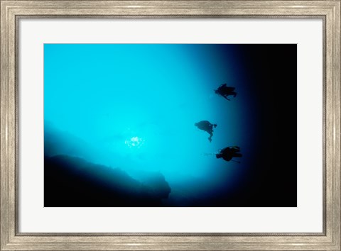 Framed Three scuba divers swimming underwater, Blue Hole, Belize Print