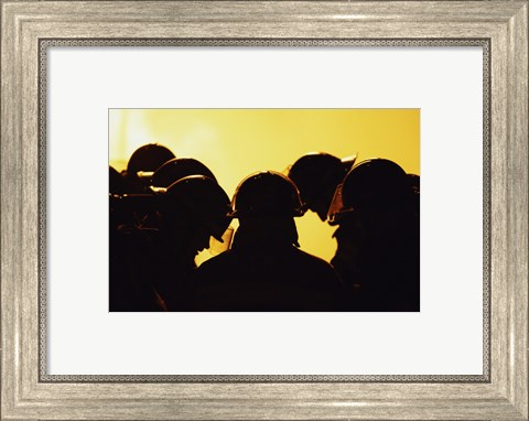Framed Rear view of a group of firefighters looking down Print