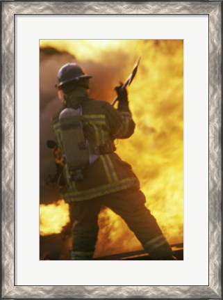 Framed Rear view of a firefighter holding an axe Print