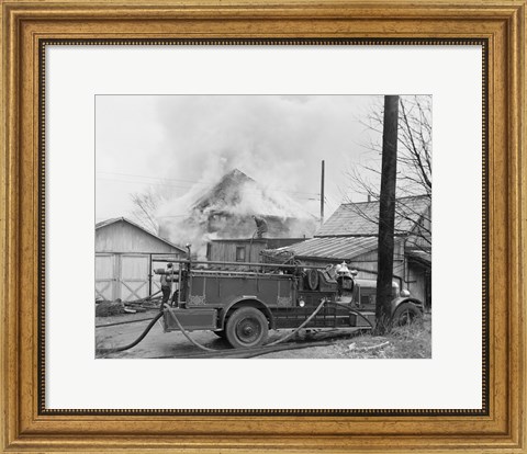 Framed Fire engine next to home in fire Print