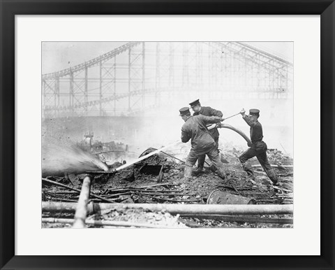 Framed Three firefighters extinguishing a fire Print