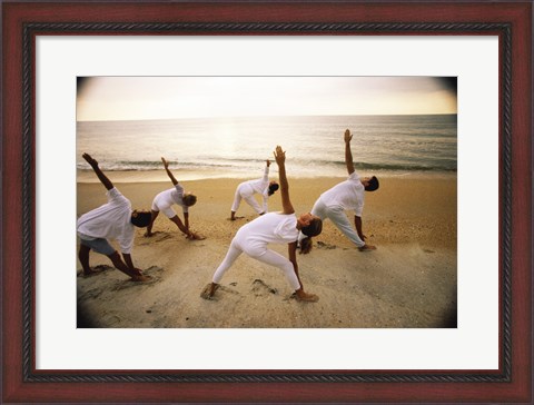 Framed Group of people performing yoga on the beach Print