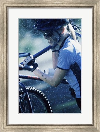 Framed Young woman carrying a bicycle on her shoulders Print