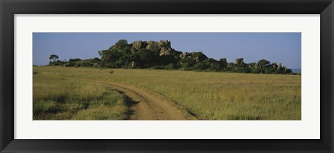 Framed Road passing through a grassland, Simba Kopjes, Road Serengeti, Tanzania, Africa Print