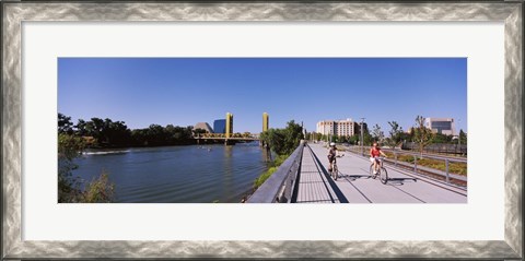 Framed Bicyclists along the Sacramento River with Tower Bridge in background, Sacramento, Sacramento County, California, USA Print