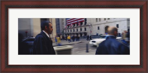 Framed Two people walking, New York Stock Exchange, Wall Street, Times Square, Manhattan, New York City, New York State, USA Print